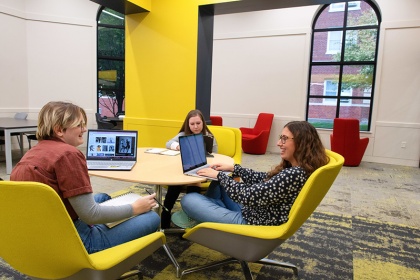 Three Iowa student sitting at a table in a study space. 